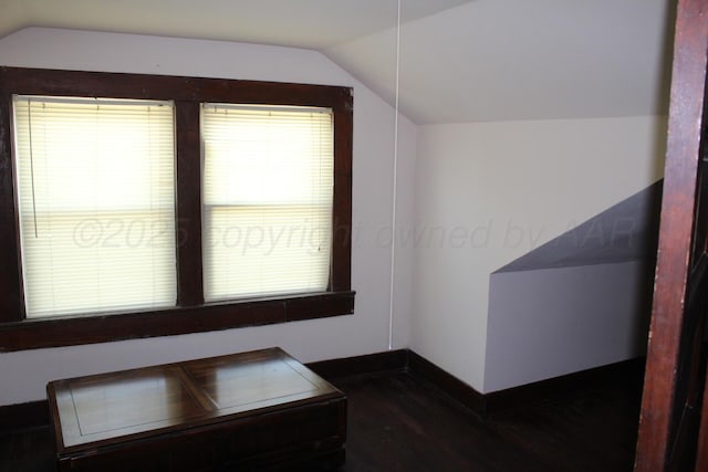 bonus room with lofted ceiling, wood finished floors, and baseboards