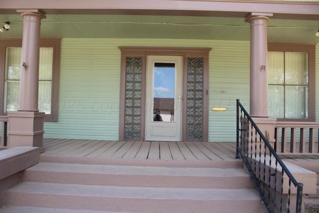 view of exterior entry featuring a porch