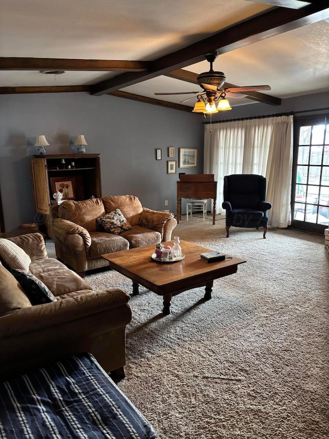 living room with vaulted ceiling with beams, a fireplace, ceiling fan, and carpet flooring