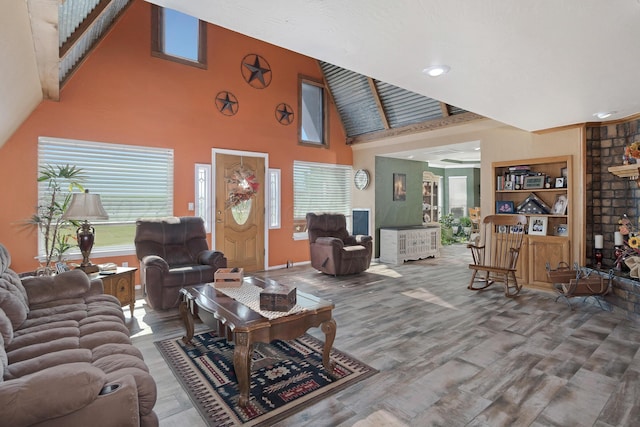 living room with a towering ceiling and hardwood / wood-style flooring