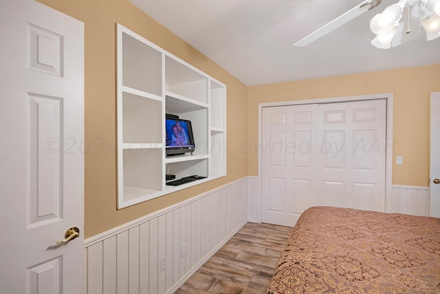 unfurnished bedroom with a closet, ceiling fan, and light hardwood / wood-style flooring