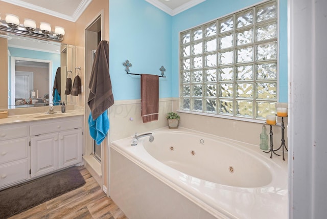 bathroom with shower with separate bathtub, ornamental molding, vanity, and hardwood / wood-style floors