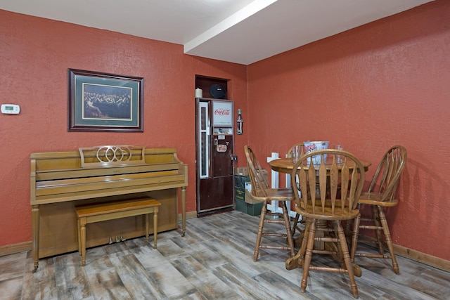 dining room with indoor bar and hardwood / wood-style flooring