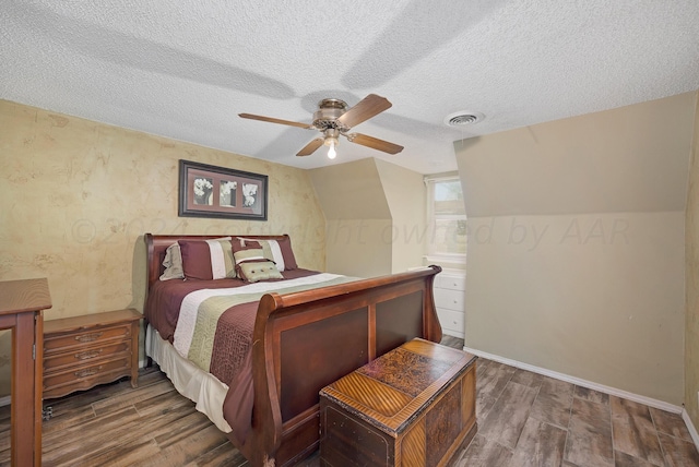 bedroom with lofted ceiling, dark wood-type flooring, a textured ceiling, and ceiling fan