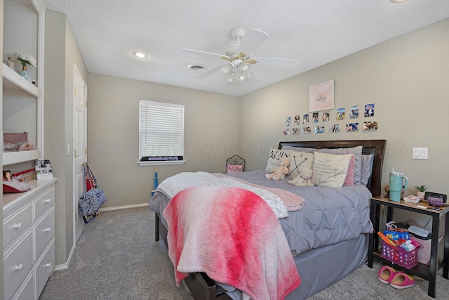 bedroom featuring ceiling fan, a textured ceiling, and carpet flooring