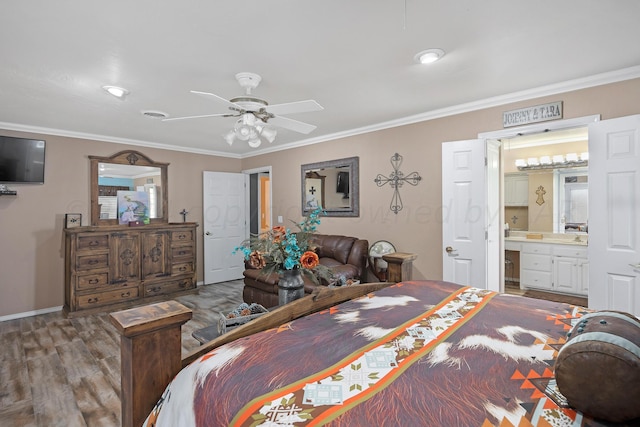 bedroom featuring ensuite bathroom, ceiling fan, crown molding, and wood-type flooring