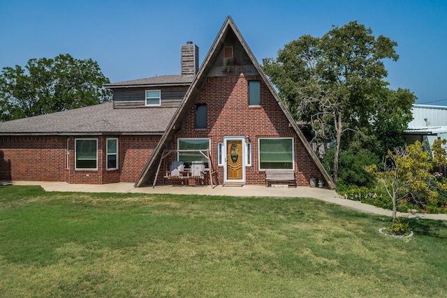 view of front of home with a patio area and a front lawn