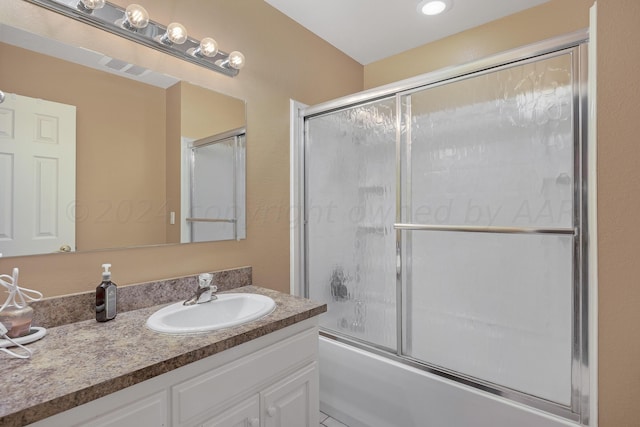 bathroom with vanity and combined bath / shower with glass door