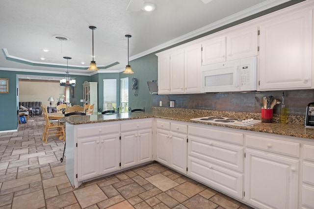 kitchen with white cabinetry, white appliances, ceiling fan, kitchen peninsula, and hanging light fixtures