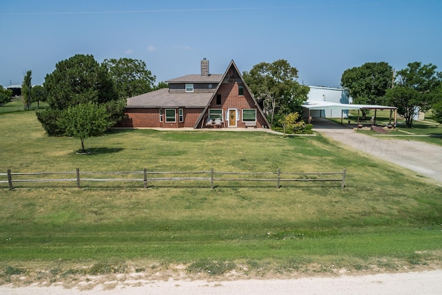 view of front of property featuring a carport, a rural view, and a front yard