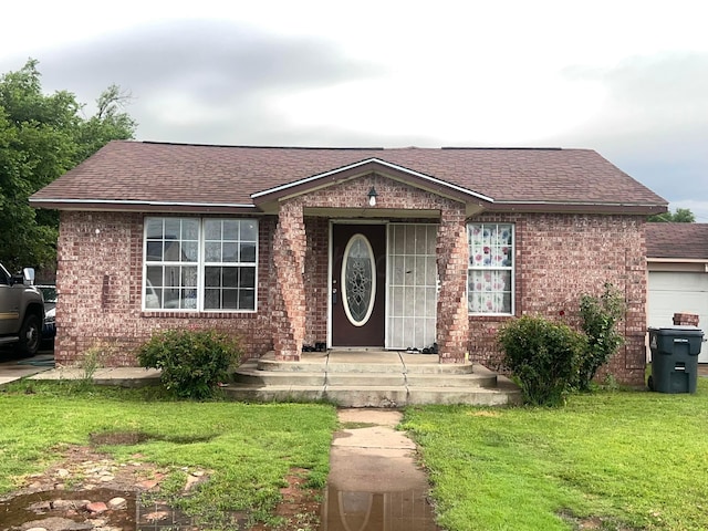 3619 NE 19th Ave, Amarillo, TX 79107 - ranch-style house featuring a front yard, brick siding, and a shingled roof