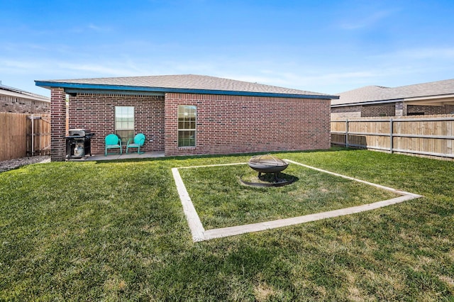 303 Loesh St, Amarillo, TX 79118 - back of house with a fenced backyard, brick siding, an outdoor fire pit, and a patio area
