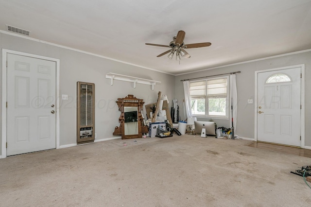 504 High St, Claude, TX 79019 - foyer with carpet, a ceiling fan, crown molding, baseboards, and a heating unit