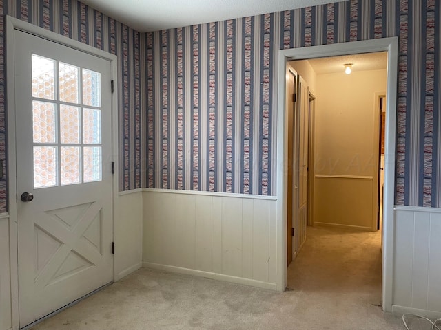 entryway featuring light colored carpet