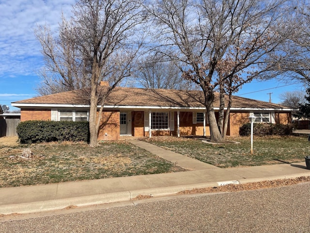 ranch-style home featuring a front yard