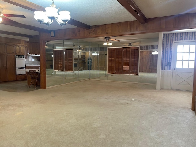 interior space featuring beamed ceiling, wooden walls, and a notable chandelier