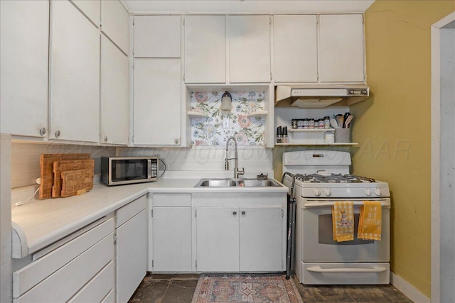 kitchen featuring white cabinetry, gas range gas stove, stainless steel microwave, light countertops, and a sink
