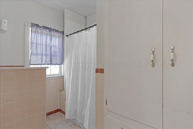 bathroom with tile patterned flooring and a shower with curtain