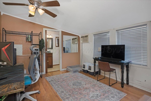 office area with a wall unit AC, vaulted ceiling, a ceiling fan, and wood finished floors