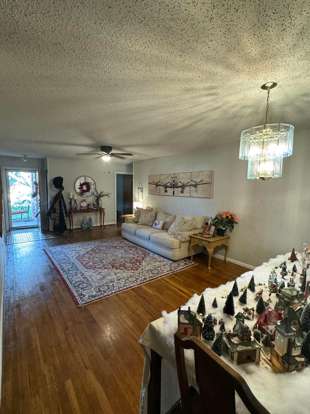 2318 Atkinsen St, Amarillo, TX 79106 - living area featuring wood finished floors, a textured ceiling, a ceiling fan, and a chandelier
