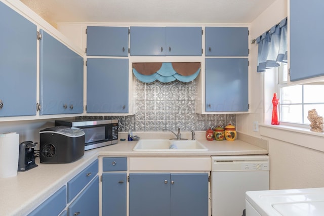 1960 S Highland St, Amarillo, TX 79103 - kitchen with dishwasher, stainless steel microwave, blue cabinets, tasteful backsplash, and light countertops