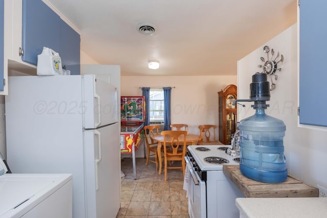 1960 S Highland St, Amarillo, TX 79103 - kitchen with washer / clothes dryer, white appliances, light countertops, and blue cabinets