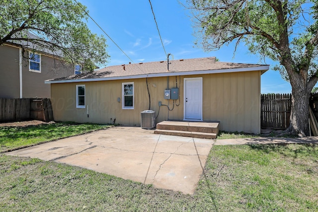 back of property featuring a yard, a patio, central AC unit, and a fenced backyard