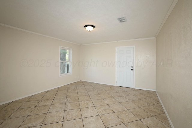 empty room with baseboards, ornamental molding, and visible vents