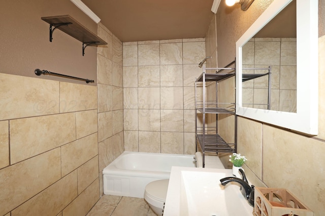 full bath with tile patterned floors, toilet, tile walls, and shower / washtub combination