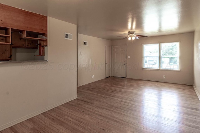 2414 Orange St, Amarillo, TX 79107 - unfurnished room with a ceiling fan, wood finished floors, and baseboards