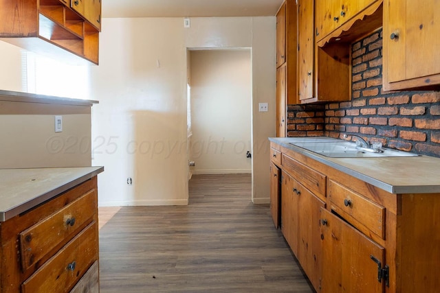 2414 Orange St, Amarillo, TX 79107 - kitchen with a sink, baseboards, dark wood-style floors, brown cabinets, and light countertops