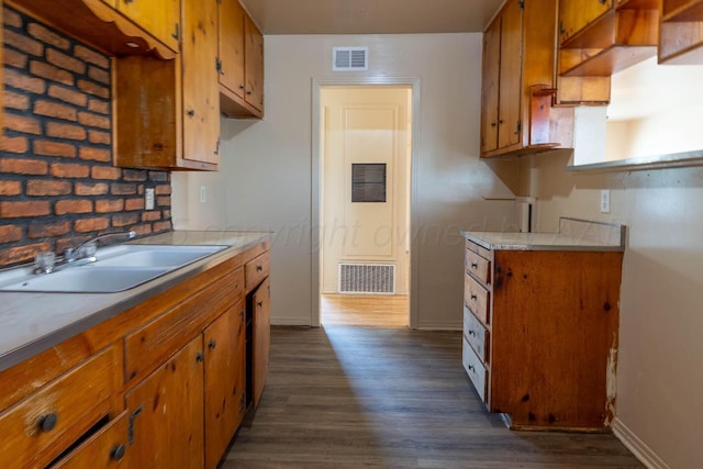 2414 Orange St, Amarillo, TX 79107 - kitchen with a sink, brown cabinetry, and dark wood-style floors