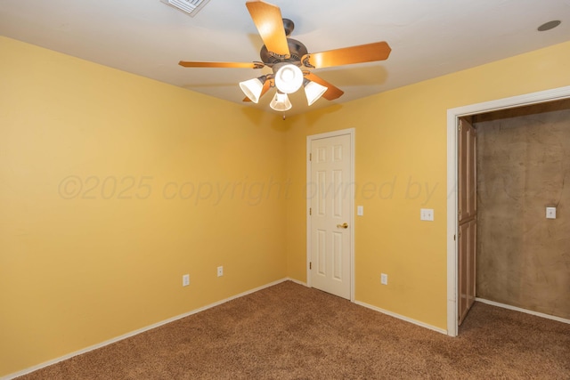 spare room featuring a ceiling fan, carpet flooring, visible vents, and baseboards