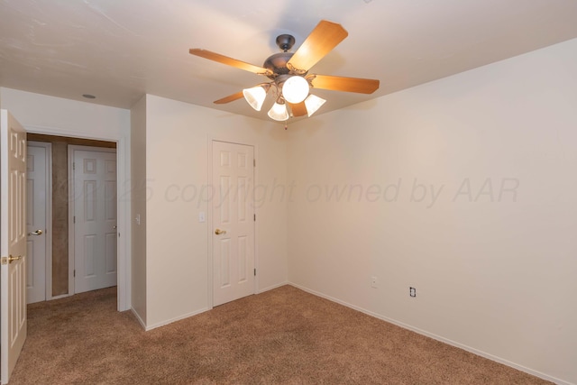 unfurnished bedroom featuring ceiling fan, carpet flooring, and baseboards