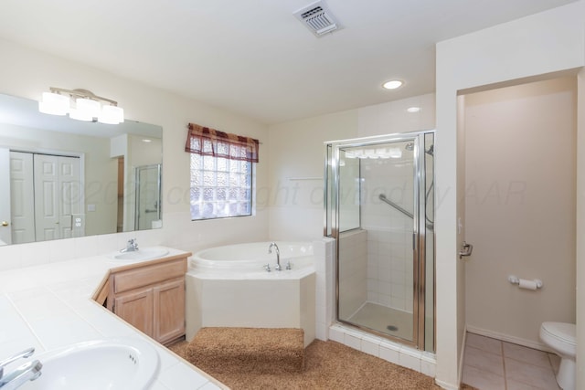 full bathroom featuring vanity, a bath, toilet, a stall shower, and visible vents