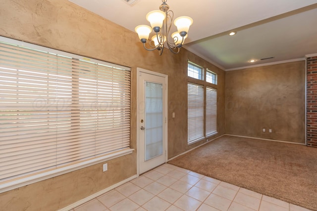 entryway with carpet flooring, a notable chandelier, crown molding, baseboards, and tile patterned flooring