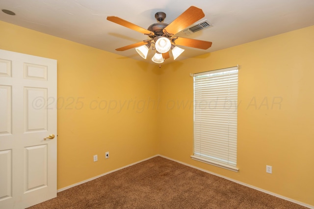 spare room featuring baseboards, visible vents, a ceiling fan, and carpet floors
