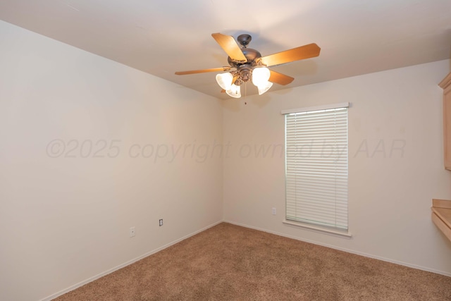 spare room featuring ceiling fan, light carpet, and baseboards