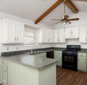 kitchen with lofted ceiling with beams, sink, dark hardwood / wood-style floors, gas stove, and white cabinetry