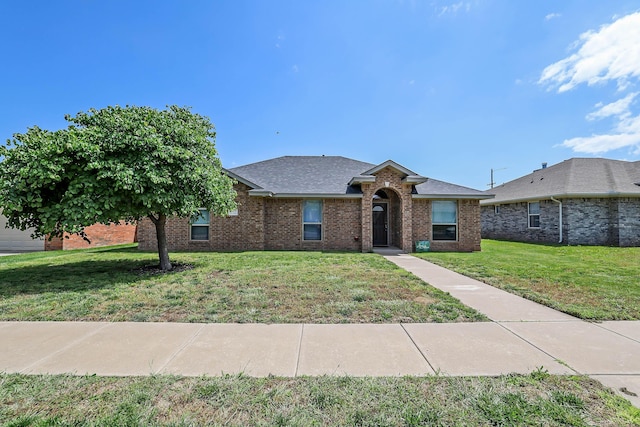 4103 San Angelo Ave, Amarillo, TX 79118 - view of front of home with a front yard, brick siding, and a shingled roof