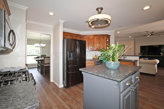 4103 San Angelo Ave, Amarillo, TX 79118 - kitchen featuring fridge with ice dispenser, ceiling fan, a kitchen island, brown cabinetry, and recessed lighting