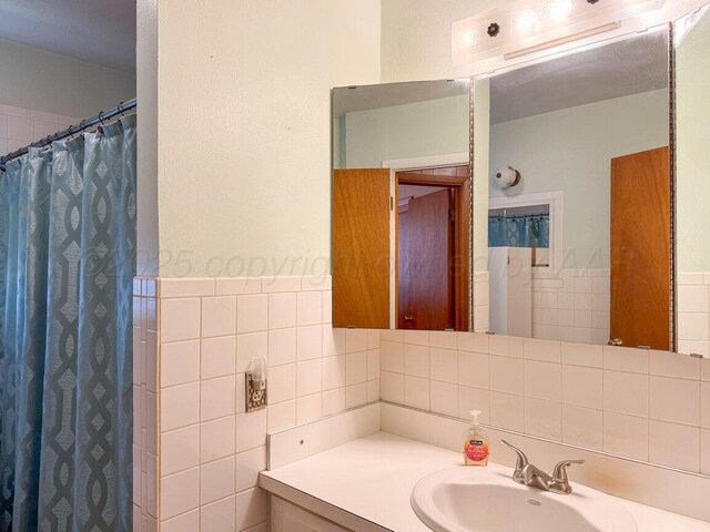 1909 N Wells St, Pampa, TX 79065 - bathroom with tile walls, vanity, and a shower with curtain