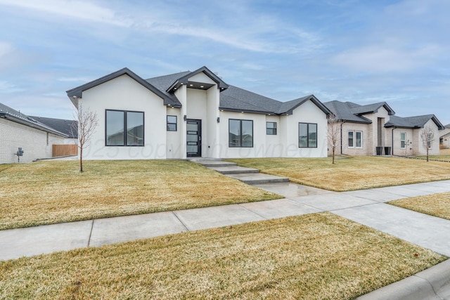 2909 Daytona Ave, Amarillo, TX 79118 - modern farmhouse featuring stucco siding, a front lawn, and a shingled roof