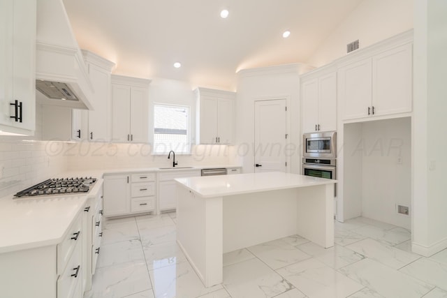2909 Daytona Ave, Amarillo, TX 79118 - kitchen with stainless steel appliances, a center island, custom range hood, white cabinetry, and recessed lighting