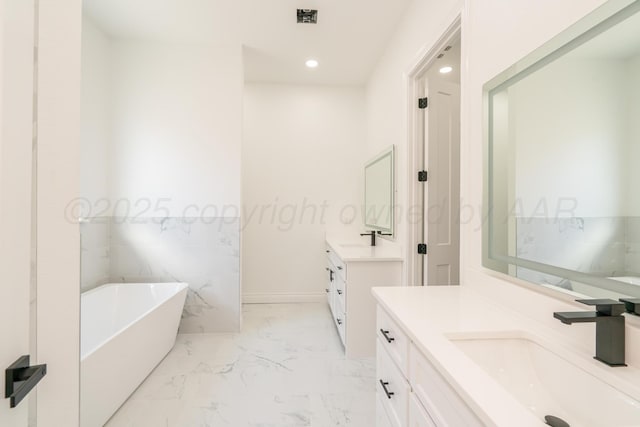 2909 Daytona Ave, Amarillo, TX 79118 - full bathroom featuring a soaking tub, two vanities, recessed lighting, and marble finish flooring