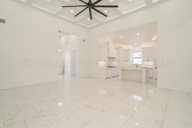 2909 Daytona Ave, Amarillo, TX 79118 - unfurnished room featuring a towering ceiling, coffered ceiling, beam ceiling, a ceiling fan, and light marble finish flooring