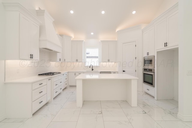 2909 Daytona Ave, Amarillo, TX 79118 - kitchen with stainless steel appliances, custom exhaust hood, a center island, decorative backsplash, and white cabinetry