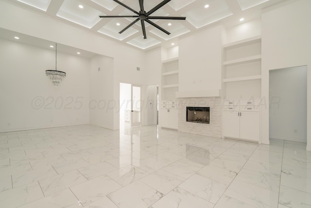 2909 Daytona Ave, Amarillo, TX 79118 - unfurnished living room with a high ceiling, ceiling fan, built in features, a tile fireplace, and coffered ceiling