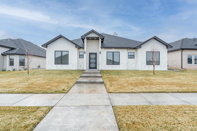 2909 Daytona Ave, Amarillo, TX 79118 - view of front facade featuring a front lawn, roof with shingles, stucco siding, and a chimney