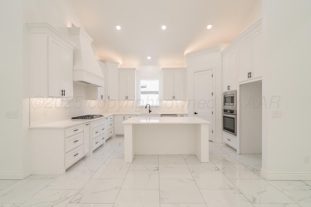 2909 Daytona Ave, Amarillo, TX 79118 - kitchen featuring stainless steel appliances, custom range hood, a center island, light countertops, and recessed lighting